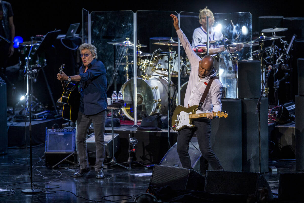 Roger Daltrey and guitarist Pete Townshend of The Who finish the song "Who Are You" a ...