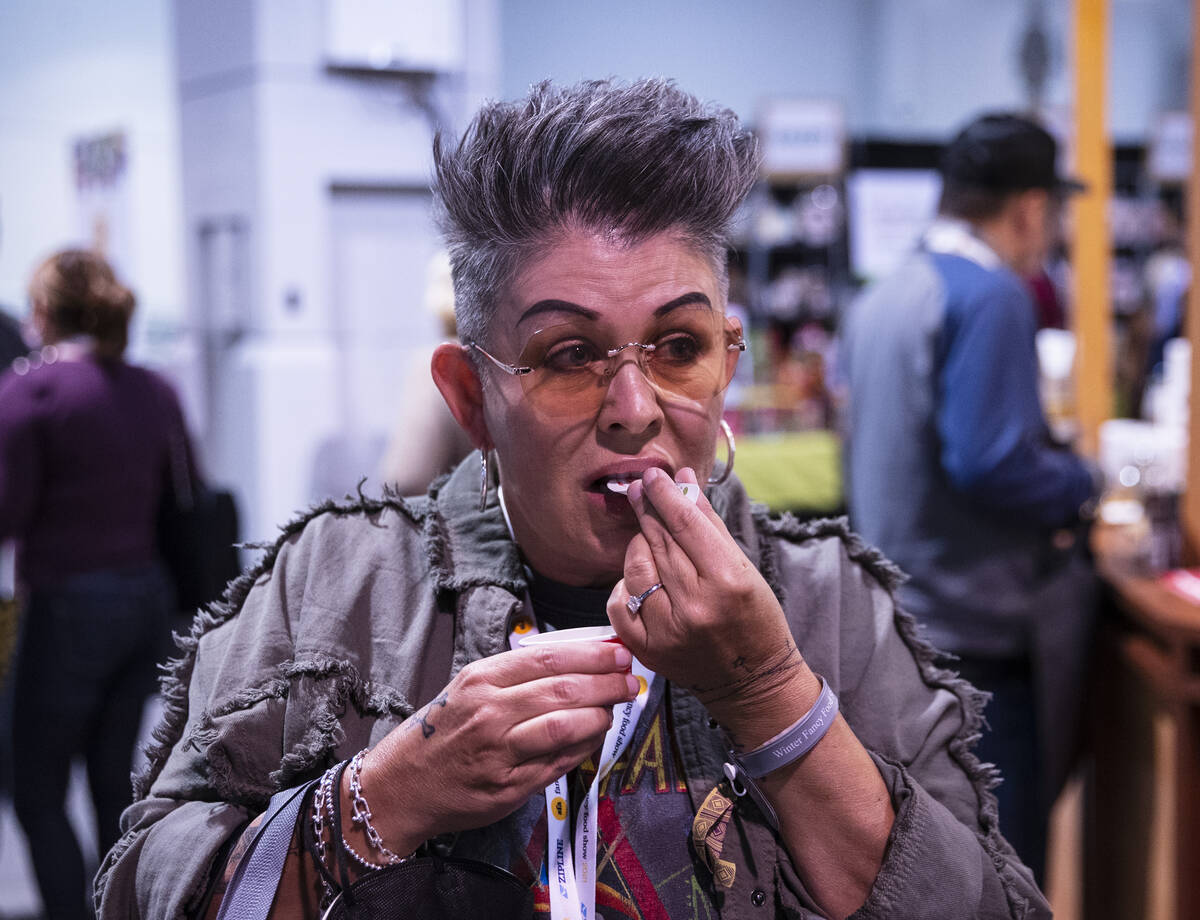 Tracy Canta Cruz of Tucson, Ariz., tests a sample of cheese with balsamic vinegar from Italy at ...