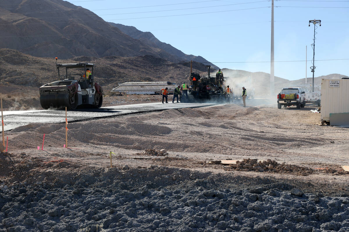 Workers pave the driveway at the Reality Based Training Center, that will prepare first respond ...