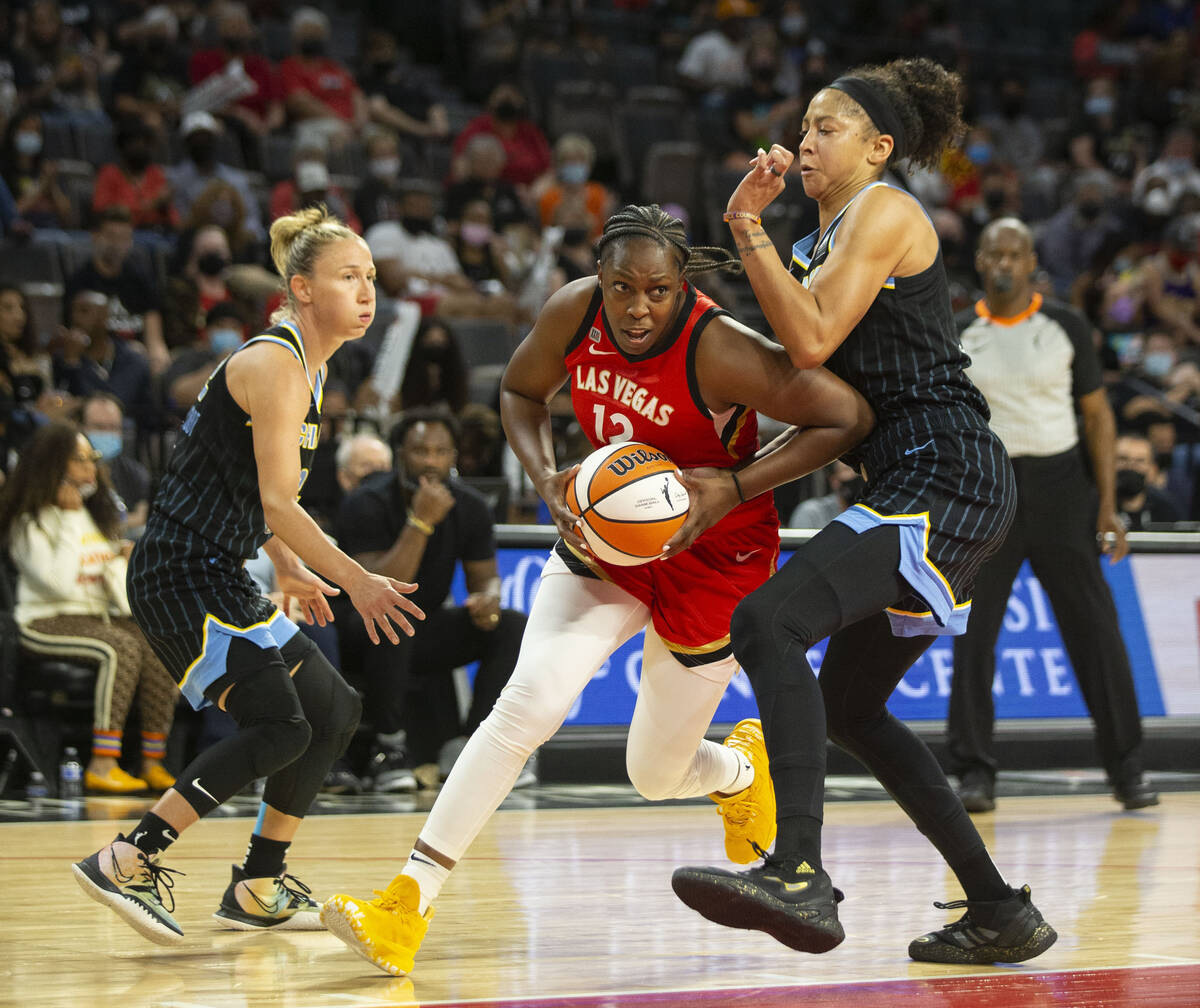 Las Vegas Aces guard Chelsea Gray (12) passes by Chicago Sky forward/center Candace Parker (3) ...