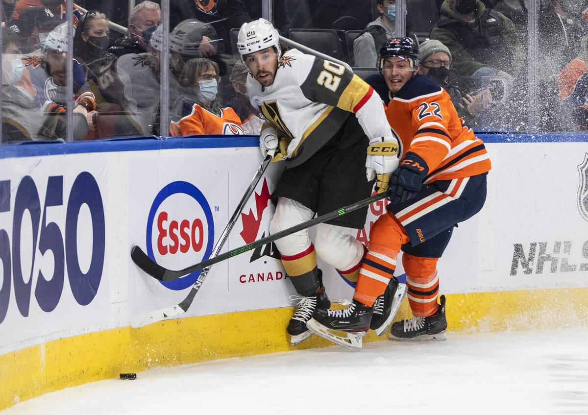 Vegas Golden Knights' Chandler Stephenson (20) and Edmonton Oilers Tyson Barrie (22) battle for ...