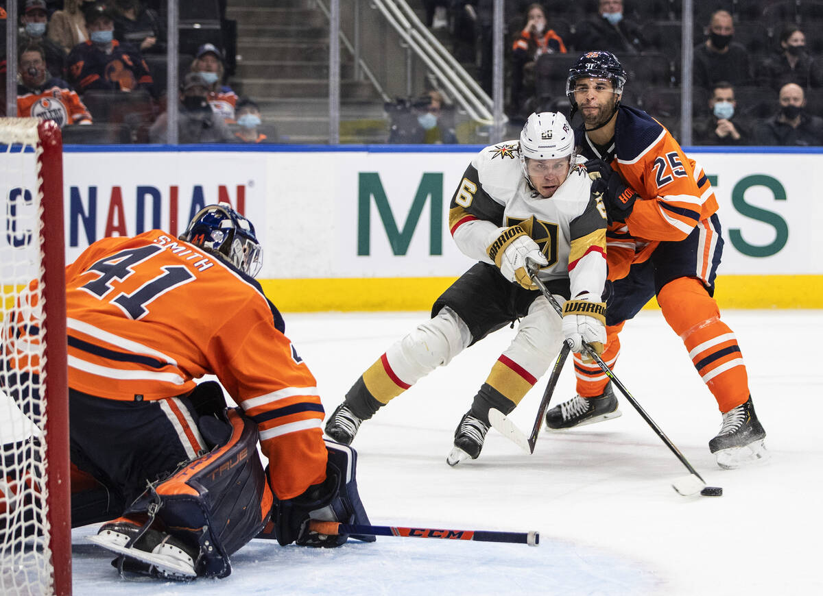 Vegas Golden Knights' Mattias Janmark (26) skates in on Edmonton Oilers goalie Mike Smith (41) ...