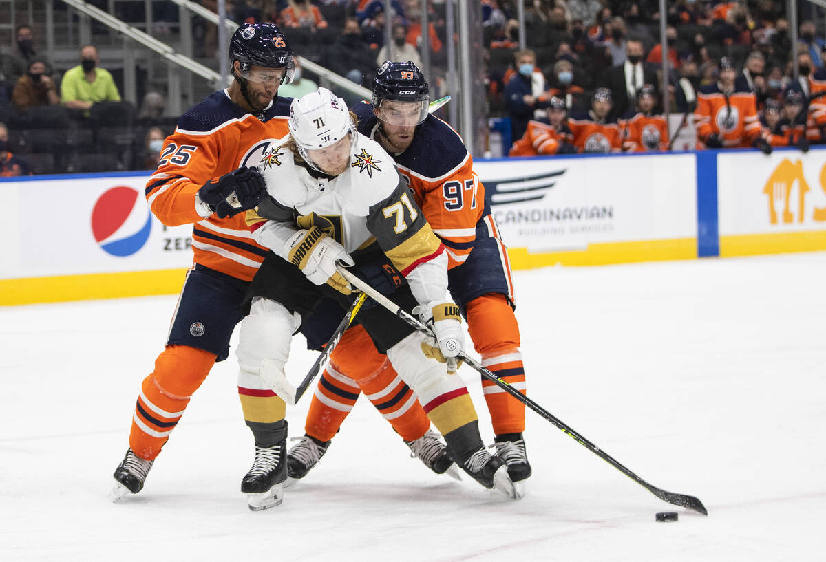 Vegas Golden Knights' William Karlsson (71) battles for the puck with Edmonton Oilers' Darnell ...