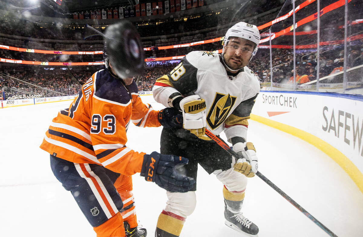 Vegas Golden Knights' William Carrier (28) and Edmonton Oilers' Ryan Nugent-Hopkins (93) battle ...