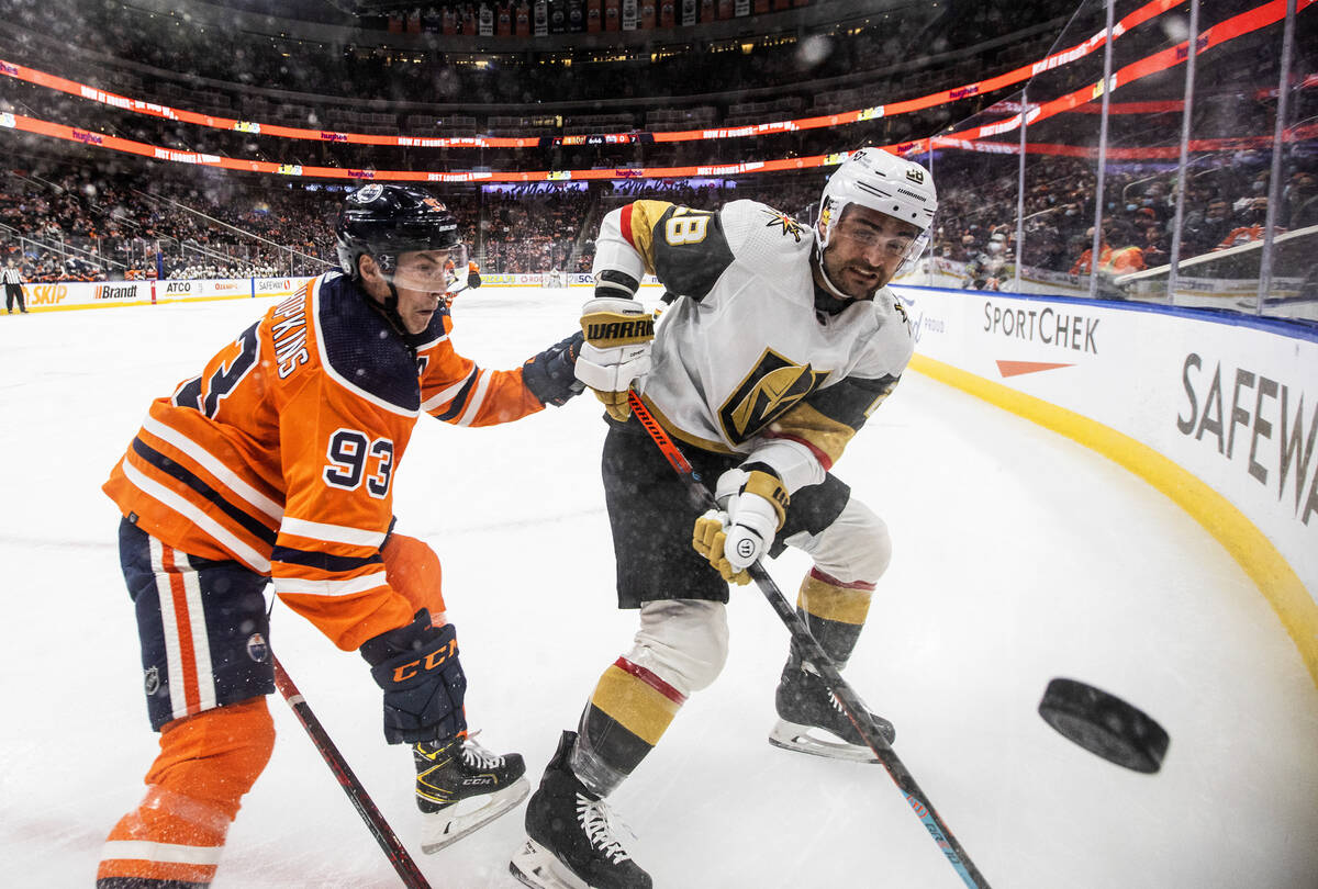 Vegas Golden Knights' William Carrier (28) and Edmonton Oilers' Ryan Nugent-Hopkins (93) battle ...