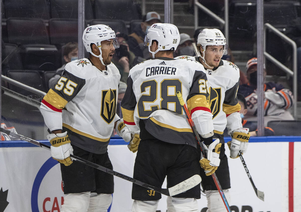 Vegas Golden Knights' Keegan Kolesar (55), William Carrier (28) and Brett Howden (21) celebrate ...