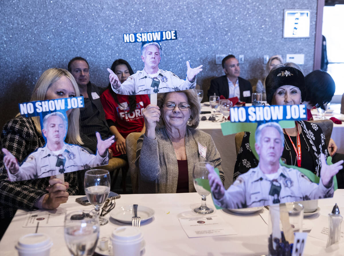 Pam Bennets, left, and Judy Leslie, center, hold cutouts of Nevada Republican governor candidat ...