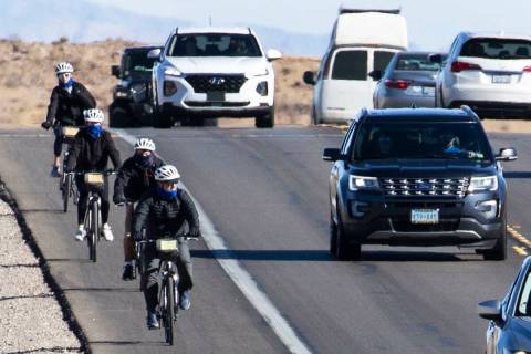 Cyclists ride their bike along the Charleston Blvd near Red Rock, on Tuesday, Dec. 29, 2020, in ...