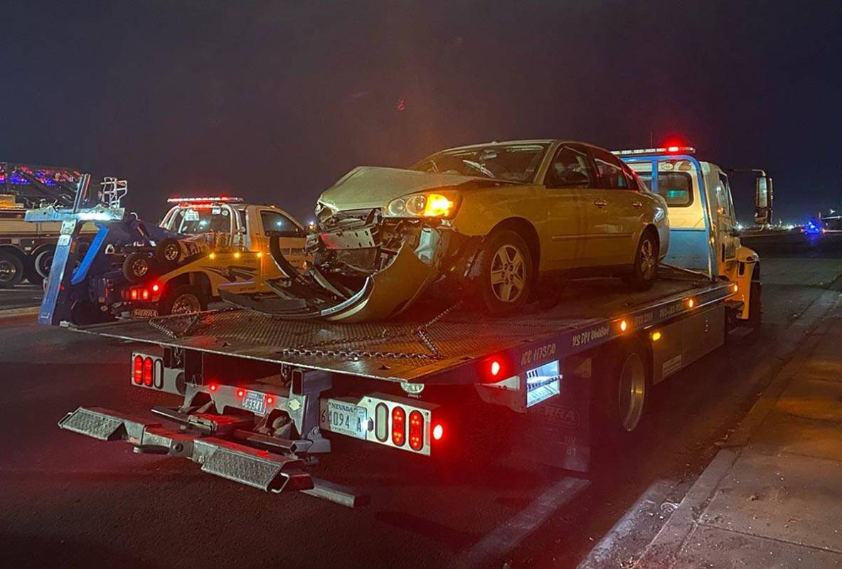 A vehicle that was involved a six-vehicle crash is towed away from the scene of a fatal acciden ...