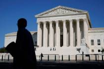 Officials stand on the Supreme Court steps on Capitol Hill in Washington, Tuesday, Sept. 22, 20 ...