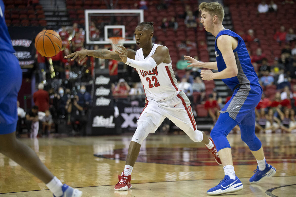 UNLV Rebels guard Josh Baker (22) passes the ball while Air Force Falcons guard Jake Heidbreder ...