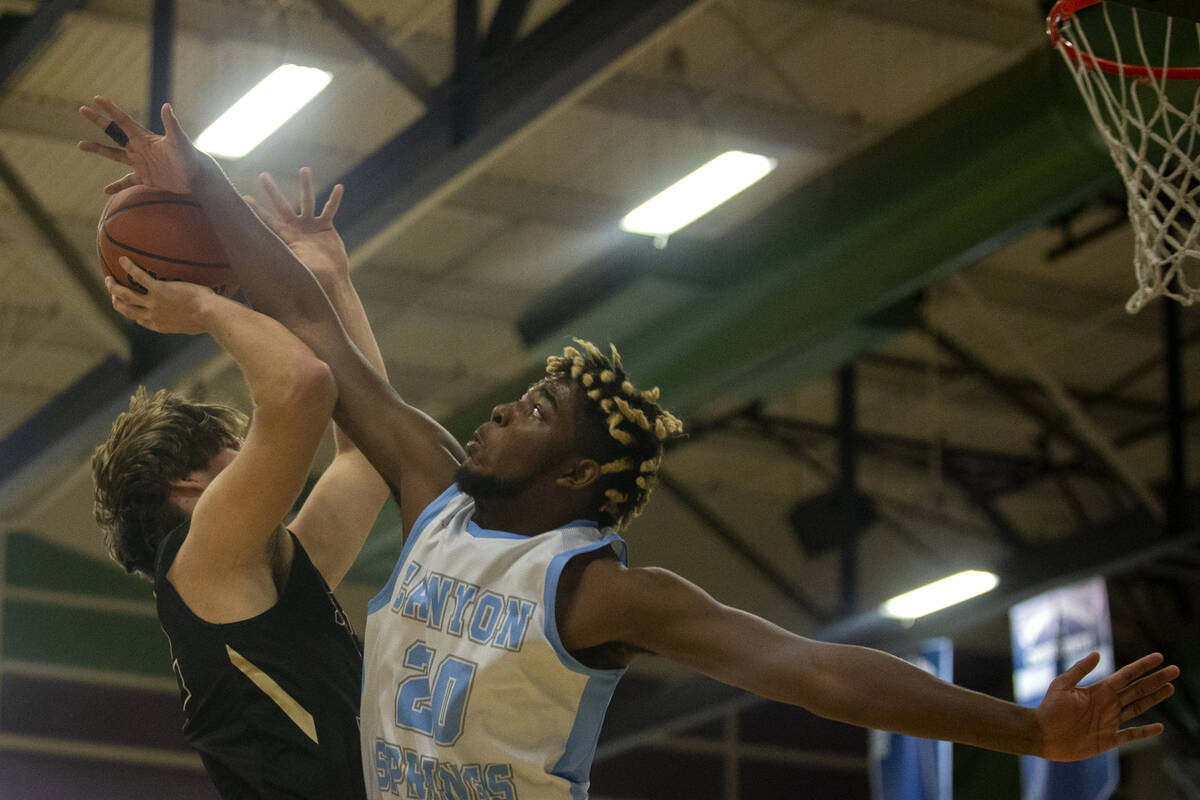 Canyon Springs forward Lorenzo Moore (20) blocks a shot attempted by Spring Valley forward Cars ...