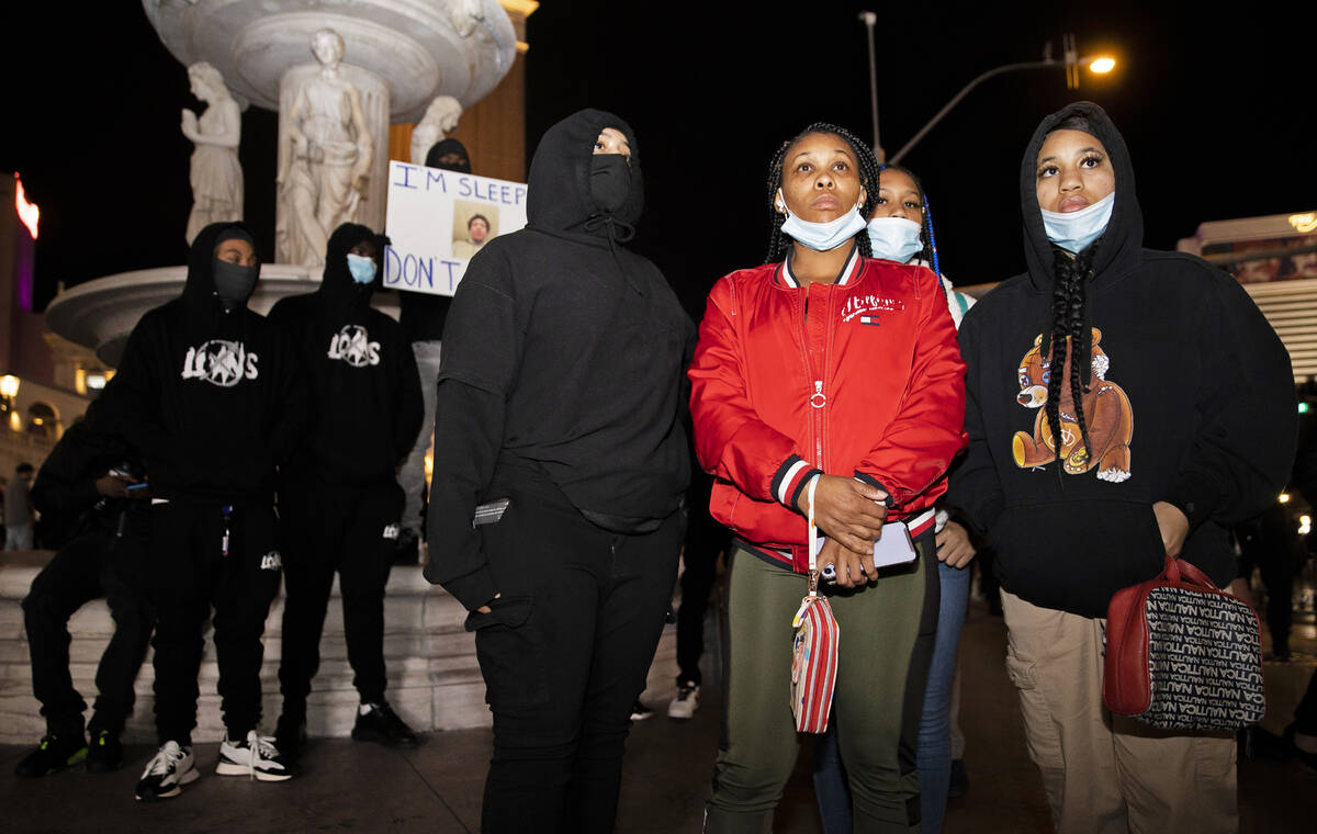 Sister Chasity Johnson, right, and mother Latia Alexander stand with protestors demanding justi ...