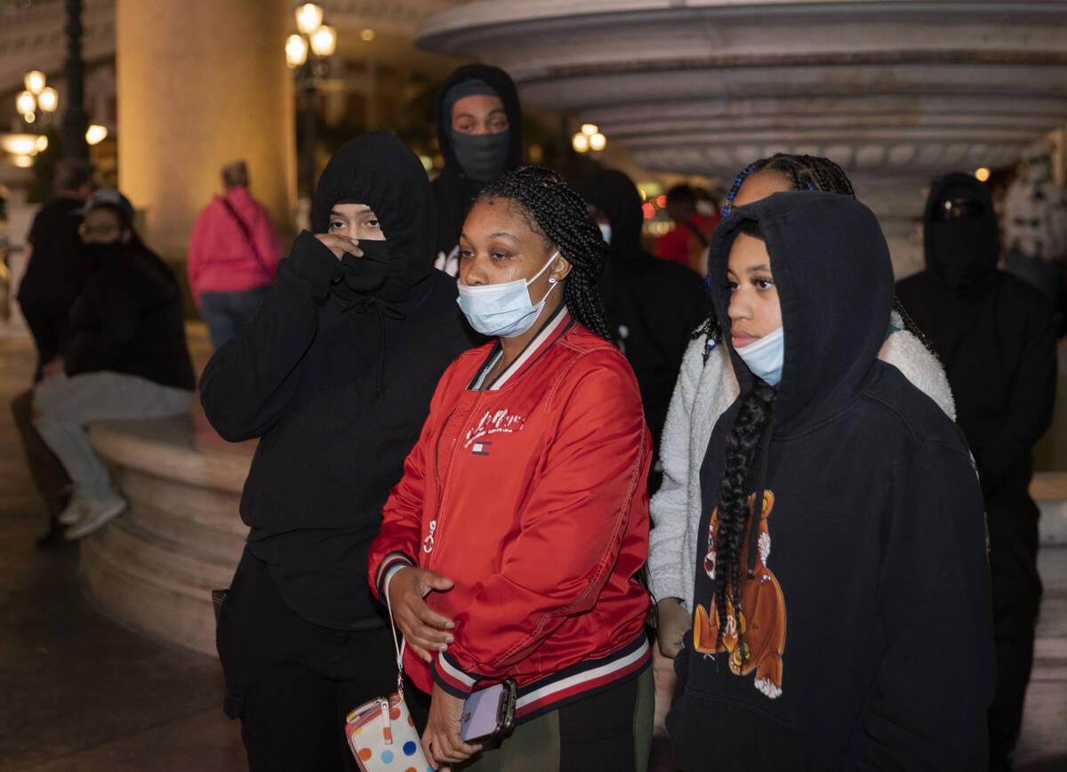 Sister Chasity Johnson, right, and mother Latia Alexander stand with protestors demanding justi ...