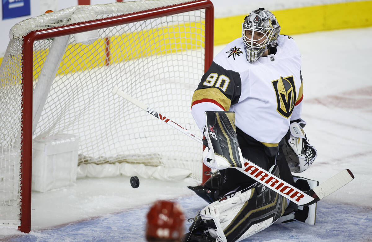 Vegas Golden Knights goalie Robin Lehner looks back as the Calgary Flames score during the firs ...
