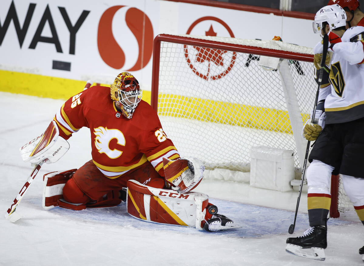 Vegas Golden Knights' Nicolas Roy, right, looks on as Calgary Flames goalie Jacob Markstrom kic ...