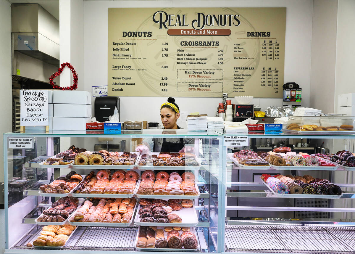 Saige Molina, manager at Real Donuts, reorganizes donuts on Thursday, Feb. 10, 2022. Sisolak li ...