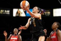 Las Vegas Aces forward Dearica Hamby (5) drives past Washington Mystics center Tina Charles (31 ...