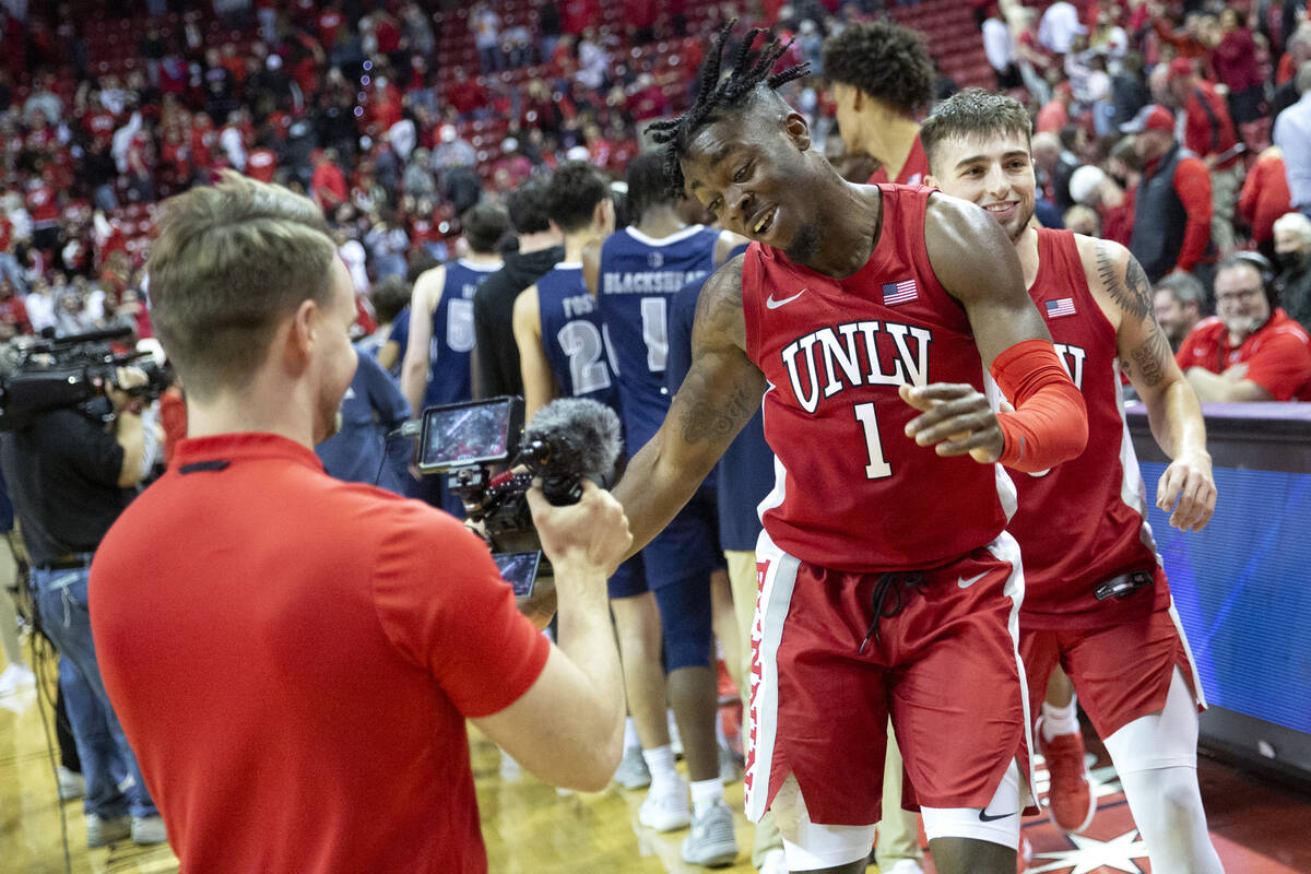UNLV Rebels guard Michael Nuga (1) and guard Jordan McCabe (5) celebrate as they leave the cour ...