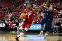 UNLV Rebels guard Michael Nuga (1) drives around Nevada Wolf Pack guard Kenan Blackshear (1) du ...