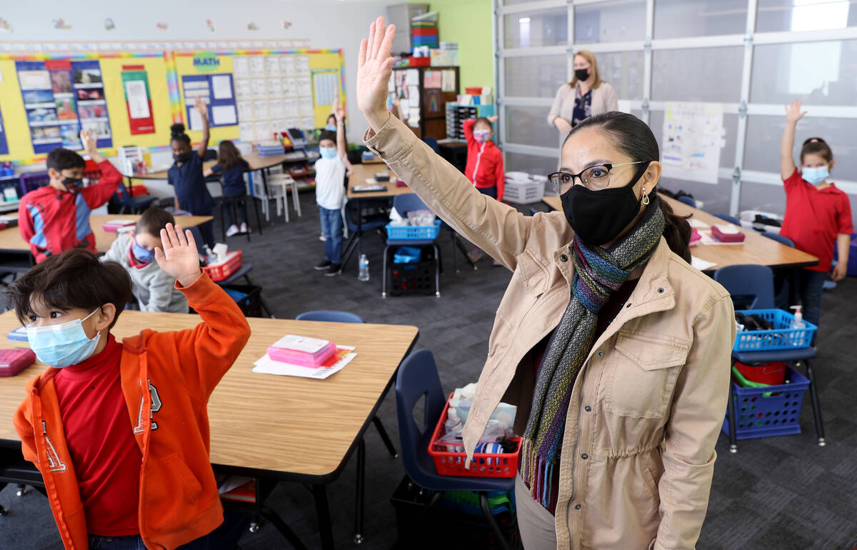 Student teacher Maria Romero works with first graders at Harris Elementary in Las Vegas Wednesd ...