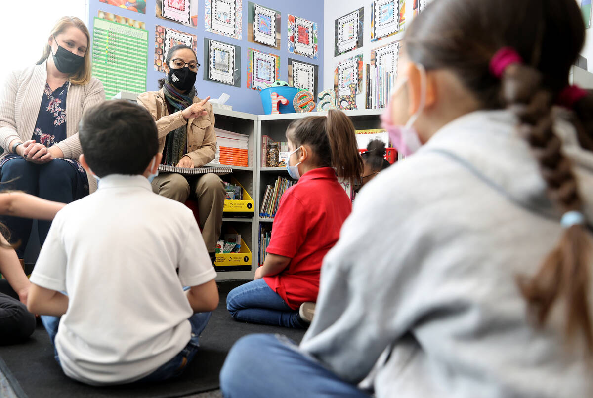 Student teacher Maria Romero, right, works with first graders under the guidance of teacher Bri ...