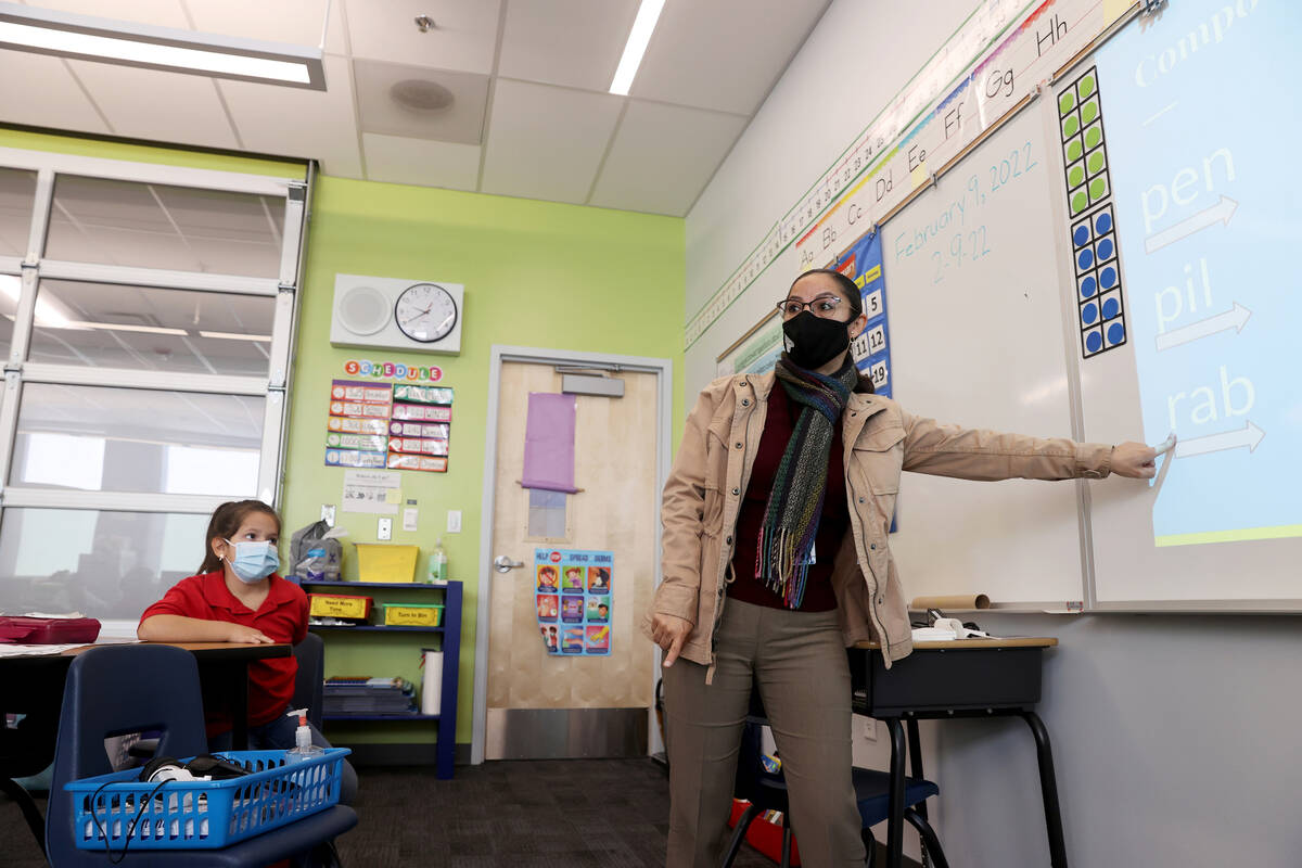 Student teacher Maria Romero works with first graders, including Bella Pedrosa, left, at Harris ...