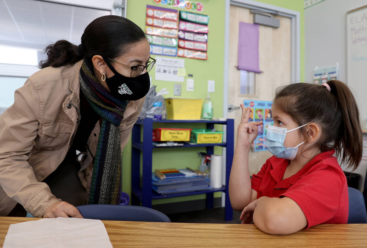 Student teacher Maria Romero works with first grader Bella Pedrosa at Harris Elementary in Las ...