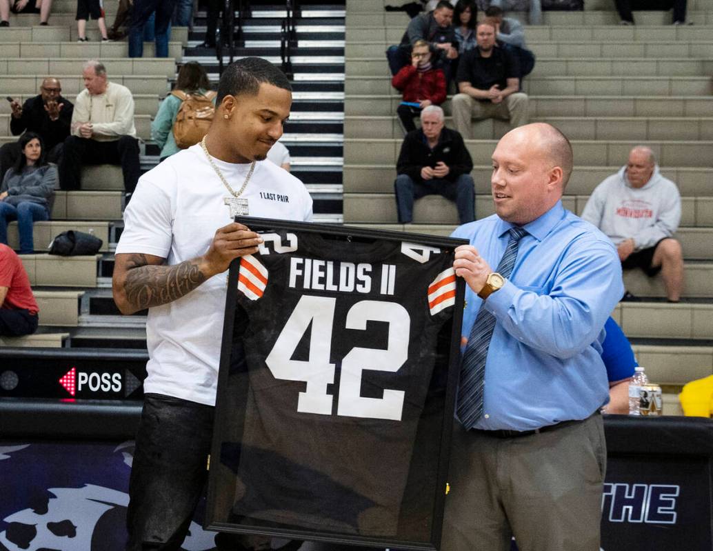 Daniel Wise, right, assistant principal of athletics, presents #42 Browns jersey to Cleveland B ...