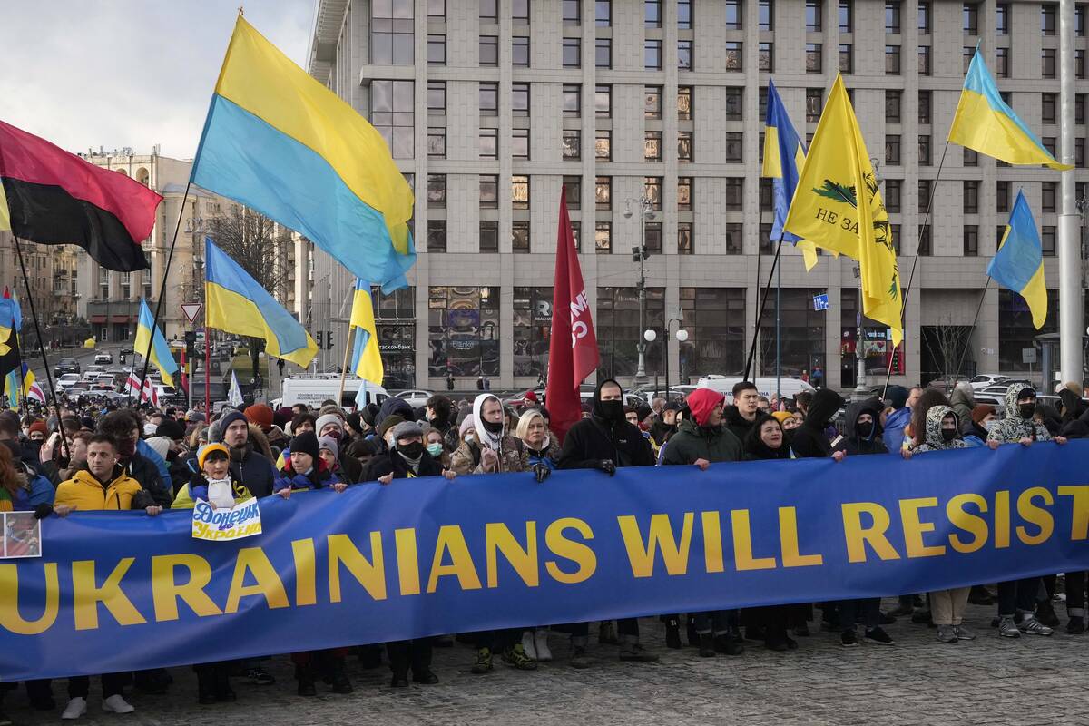 Ukrainians attend a rally in central Kyiv, Ukraine, Saturday, Feb. 12, 2022, during a protest a ...