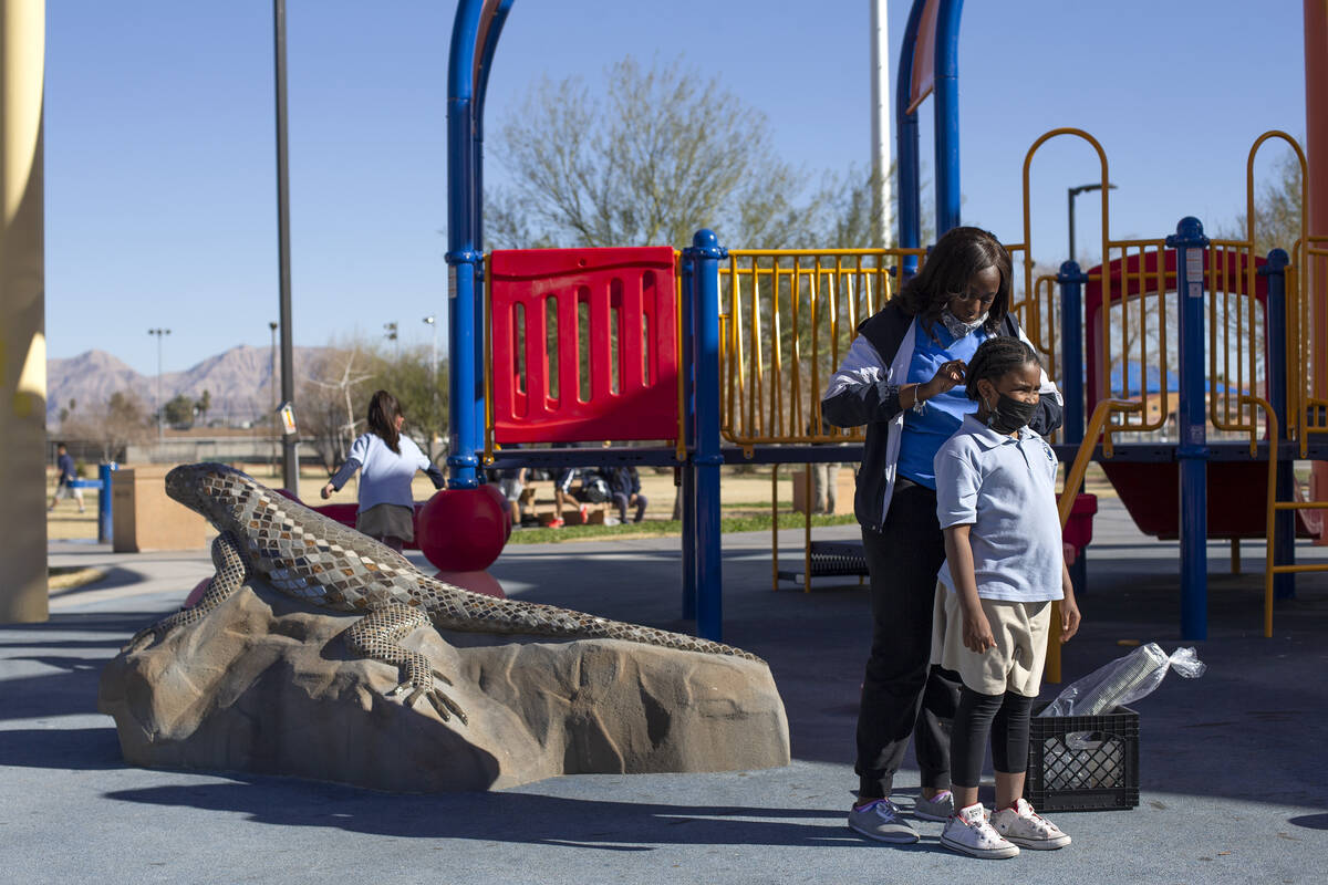 Jaalah Lewis, lead assistant for Doolittle Community Center’s after-school program, braids De ...