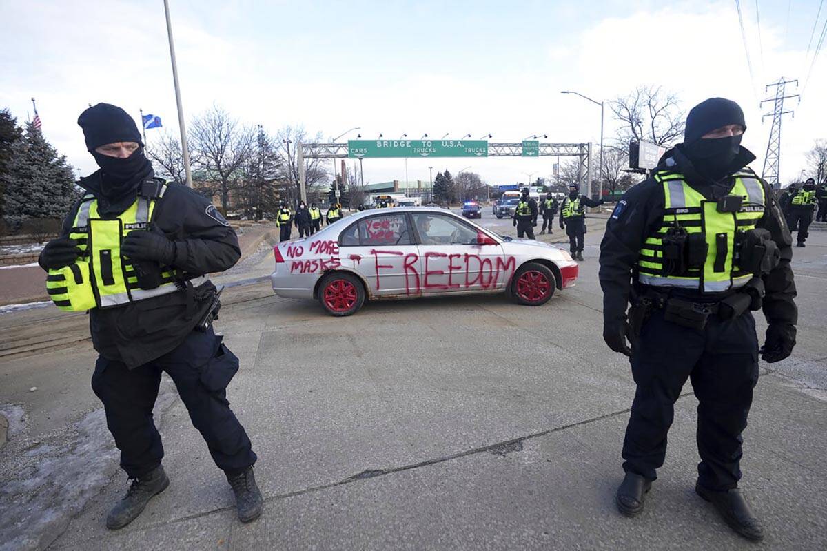 Police look on as a protest vehicle leaves a demonstration which has blocked traffic across the ...