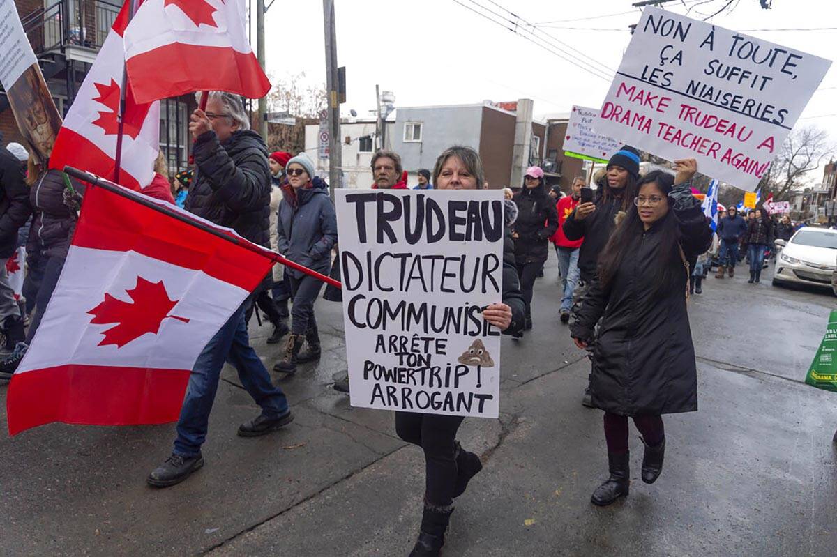 Protesters against COVID-19 restrictions march through the streets of Montreal on Saturday, Feb ...