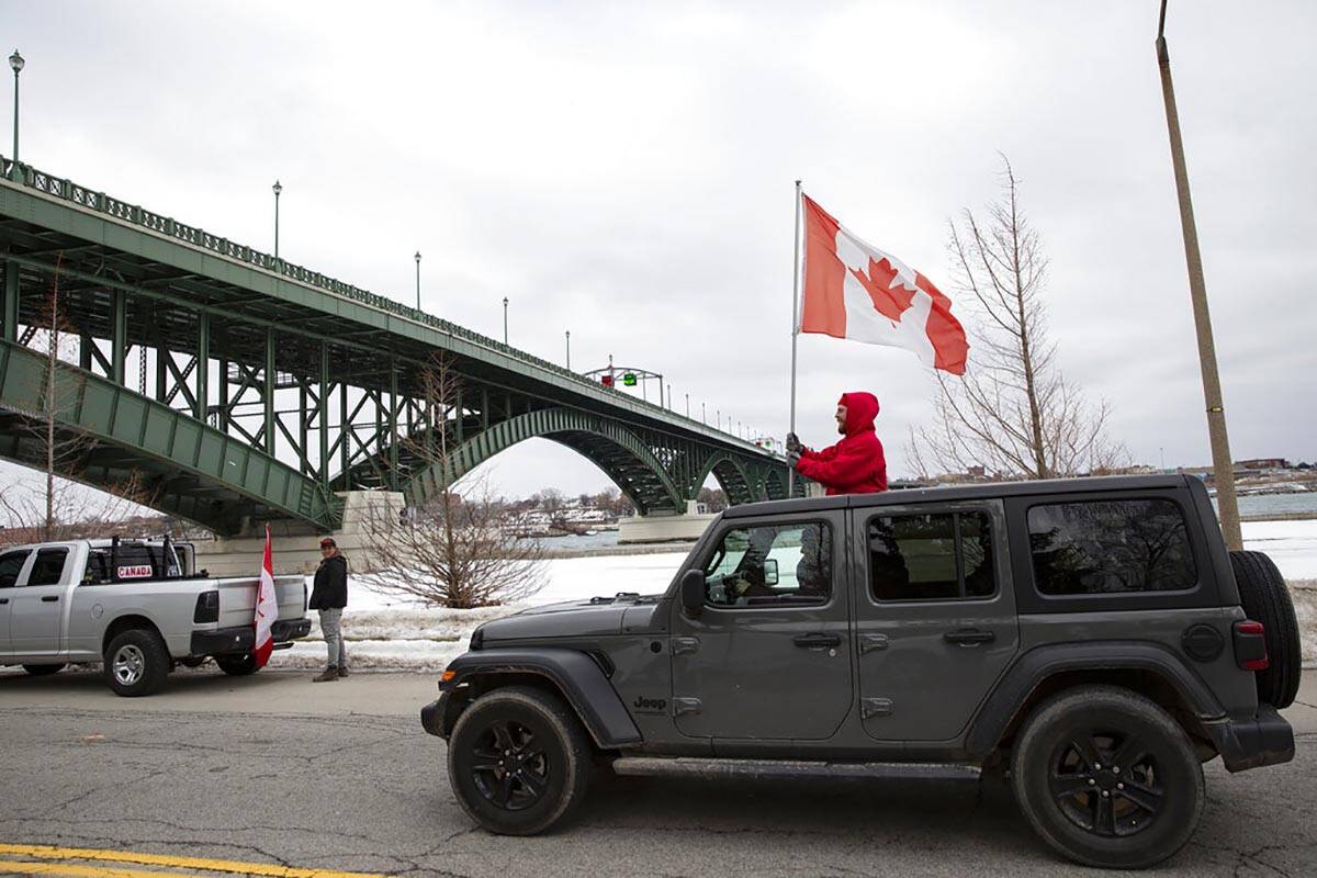 Demonstrators in opposition to COVID-19 mandates protest under the Peace Bridge in Fort Erie, O ...