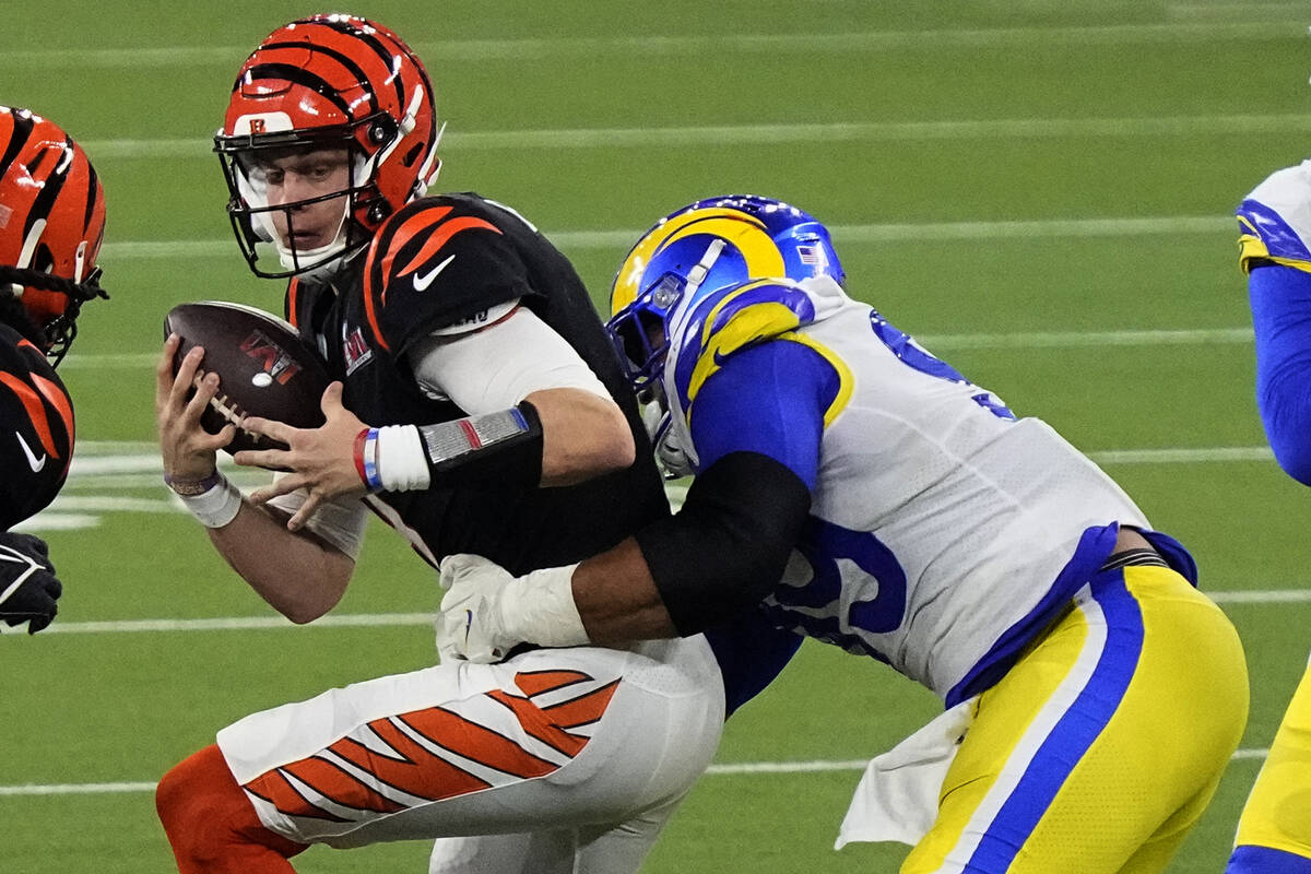 Los Angeles Rams defensive end Aaron Donald (99) tackles Cincinnati Bengals quarterback Joe Bur ...