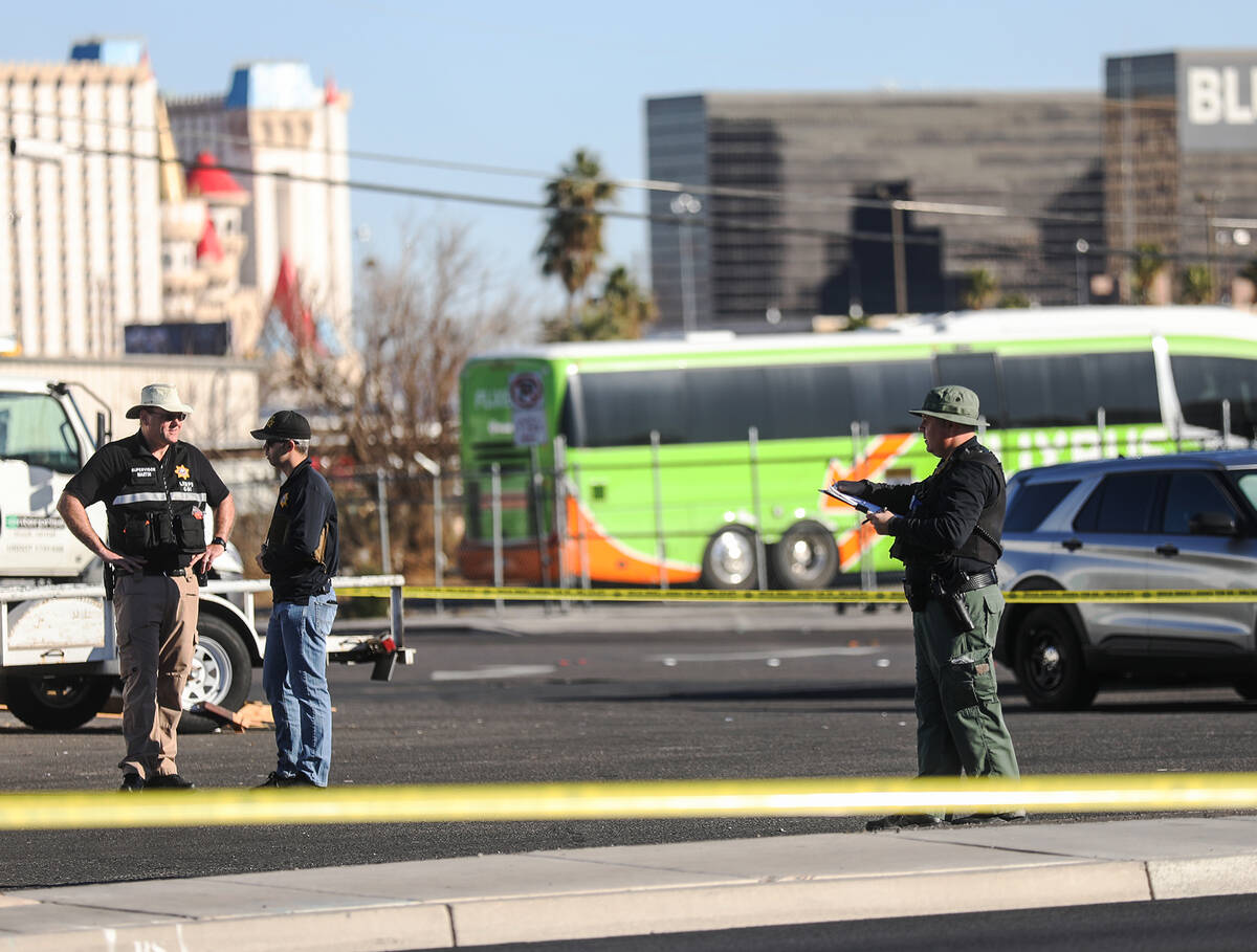 Police investigate the scene where a warehouse employee fatally shot a man who was stealing his ...