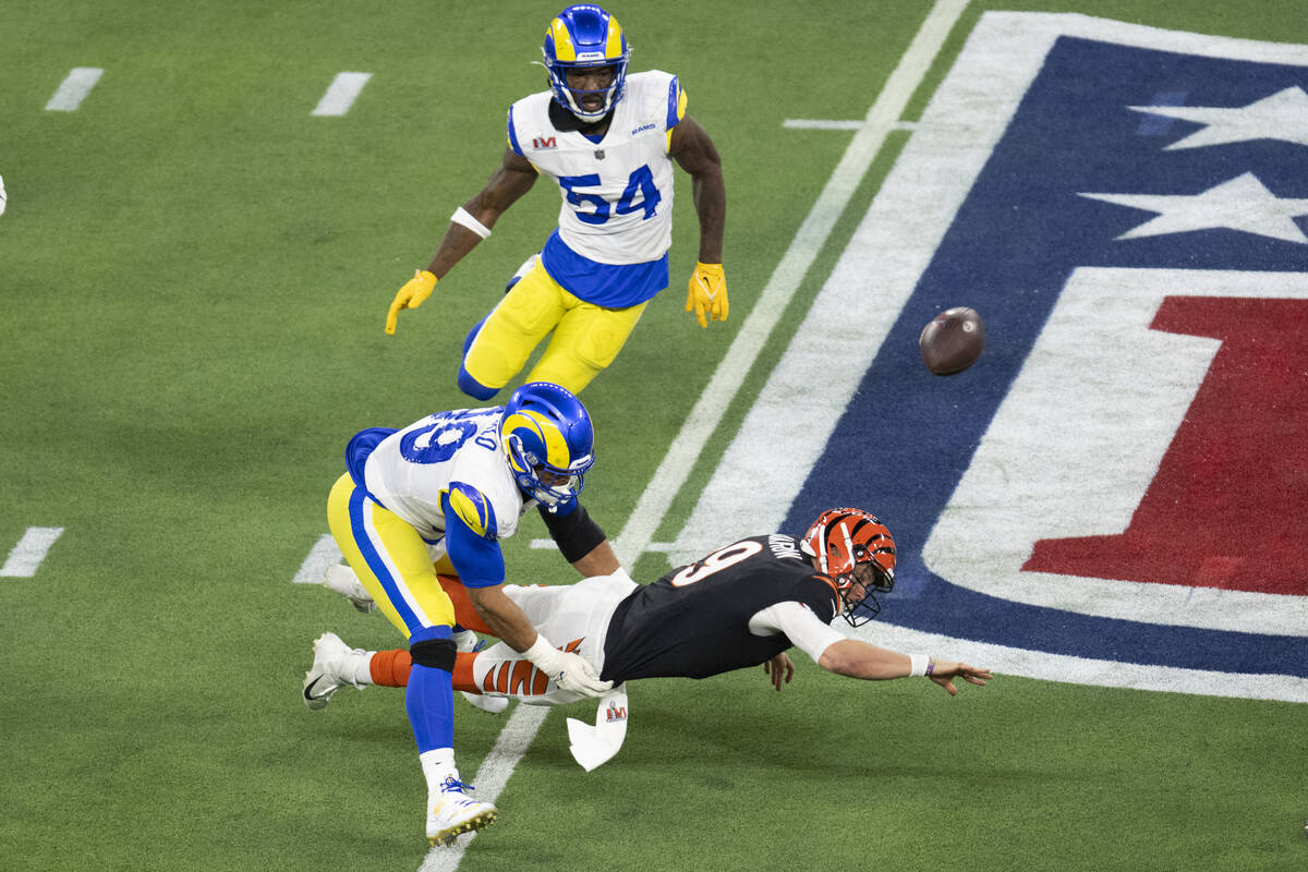 Los Angeles Rams defensive end Aaron Donald (99) forces Cincinnati Bengals quarterback Joe Burr ...