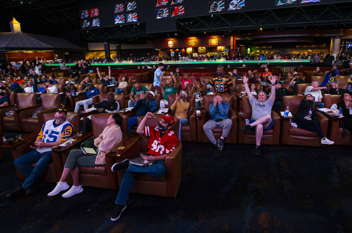 Football fans cheer after a touchdown by Cooper Kupp of the Los Angeles Rams during a Super Bow ...