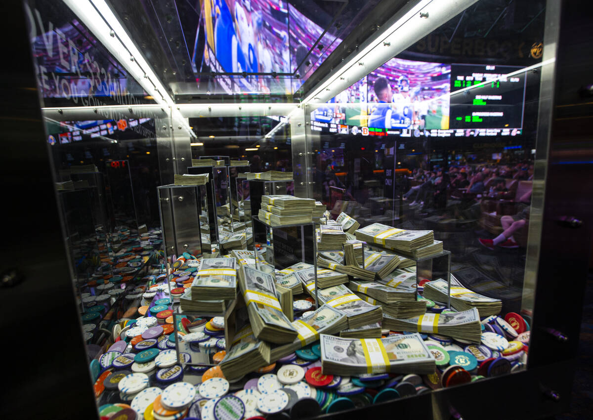 Promotional money and chips are displayed as attendees take in the action during a Super Bowl w ...