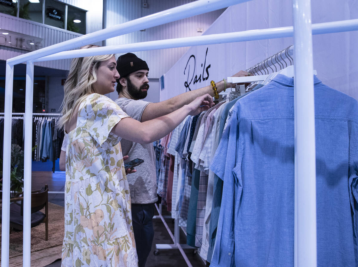 Shyann Lee, left, and Julian Michael, sales representatives, display shirts at Rails’ bo ...
