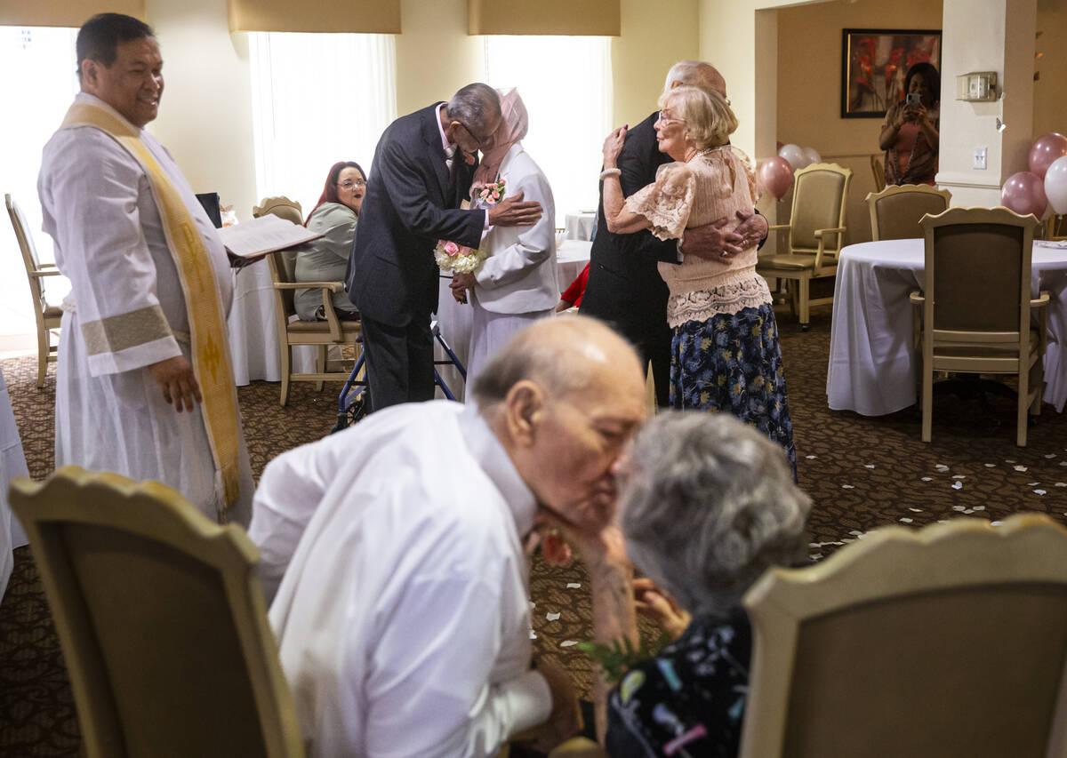 Pastor Jeremiah Castorillo, left, looks on during a Valentine's Day vow renewal ceremony with p ...