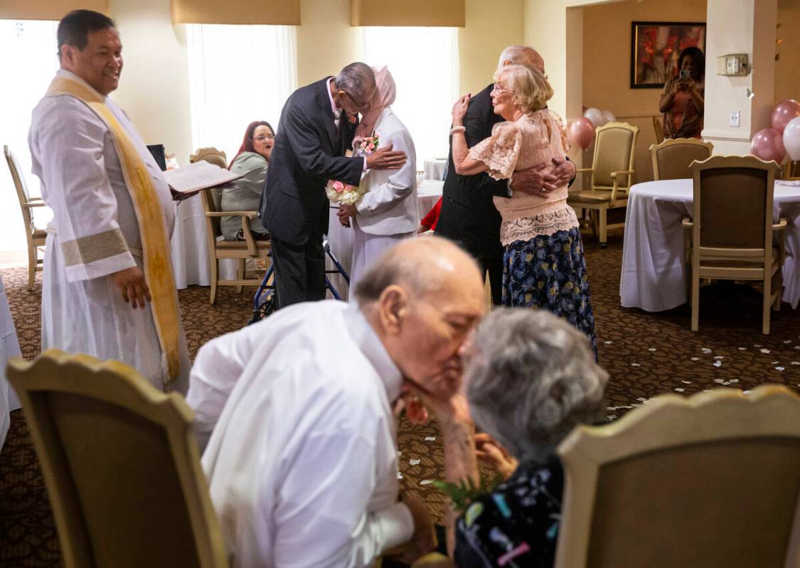 Pastor Jeremiah Castorillo, left, looks on during a Valentine's Day vow renewal ceremony with p ...