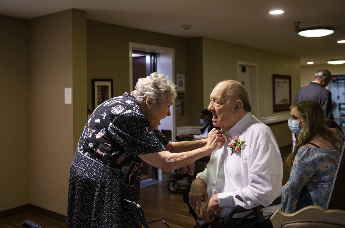 Edith Vines-Bauer, left, adjusts the bowtie her husband, David Bauer, before the start of a gro ...