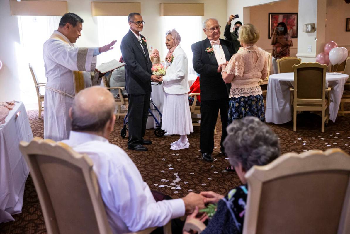 Pastor Jeremiah Castorillo, left, leads a group Valentine's Day vow renewal ceremony with parti ...