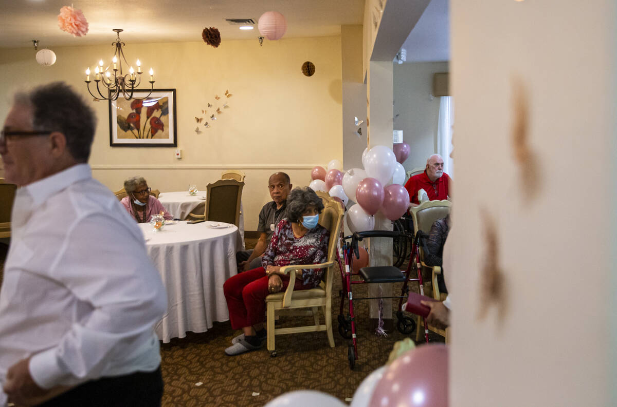 Attendees look on during a group vow renewal ceremony on Valentine's Day at Sterling Ridge Seni ...