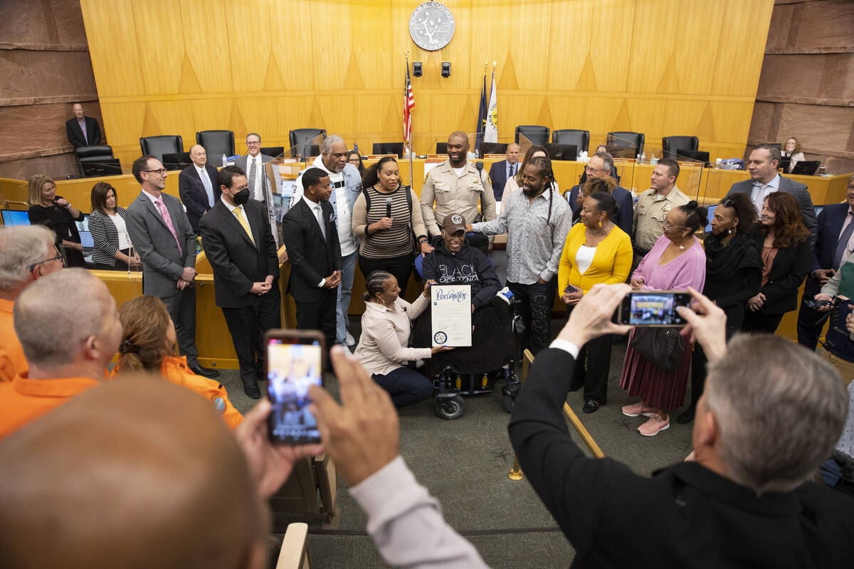 Retired Las Vegas police officer Herman Moody, 97, center, surrounded by family is recognized f ...