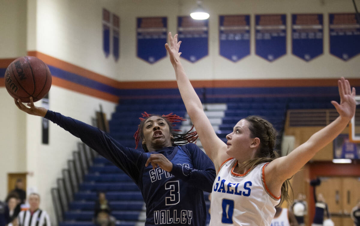 Spring Valley guard Aaliyah Gayles (3) drives past Bishop Gorman guard Silvia Garcia (1) in the ...