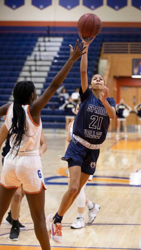 Spring Valley guard Charolette Delisle (21) shoots over Bishop Gorman forward Kira Williams (35 ...