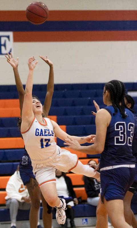 Bishop Gorman guard Selina Gutierrez (12) goes baseline past Spring Valley forward Rayne Dunn ( ...