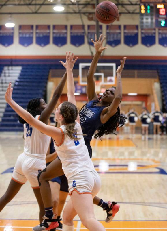 Spring Valley forward Rayne Dunn (22) shoots over Bishop Gorman forward Kira Williams (35) and ...